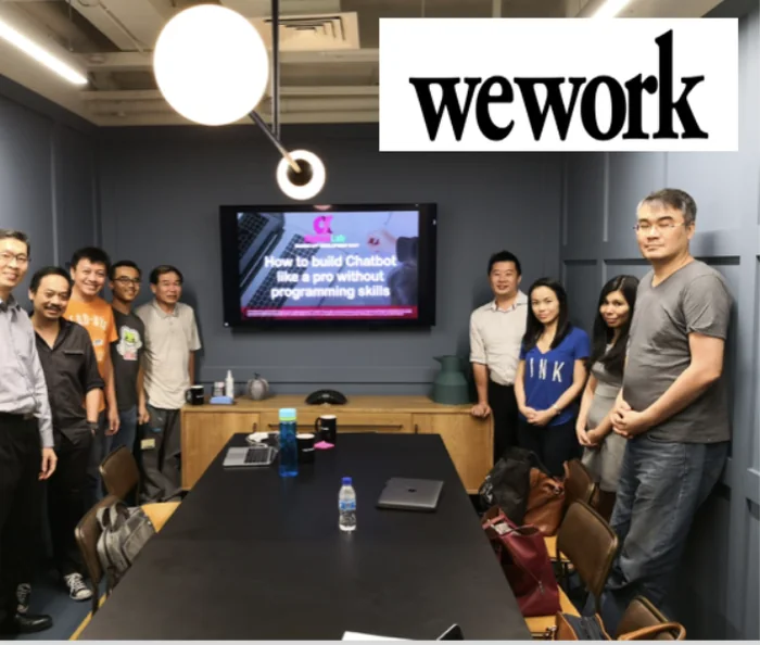 Participants gathered around a conference table after a chatbot workshop at WeWork